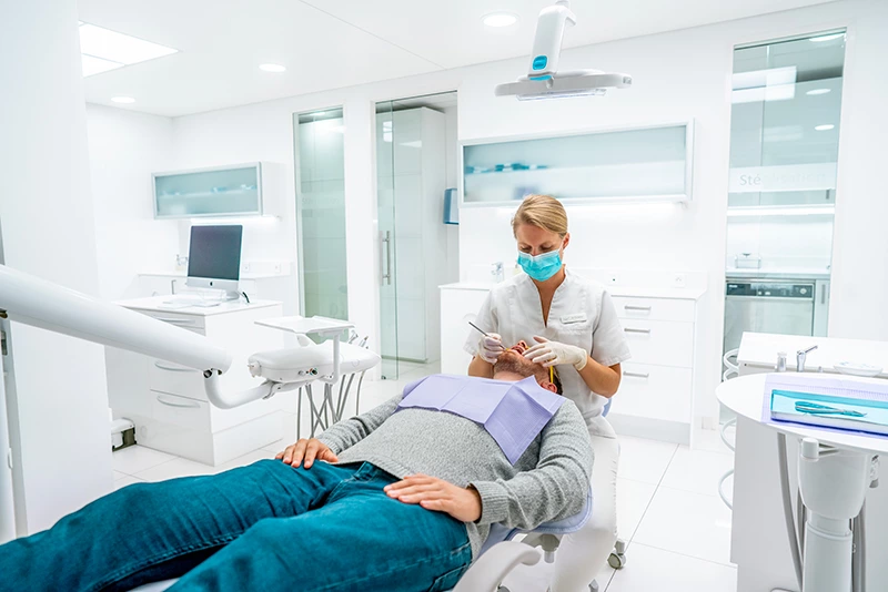 Photographie d'un dentiste réalisant une opération